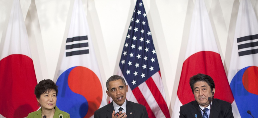 President Barack Obama meets with Japanese Prime Minister Shinzo Abe, right, and South Korean President Park Geun-hye, Tuesday, March 25, 2014.