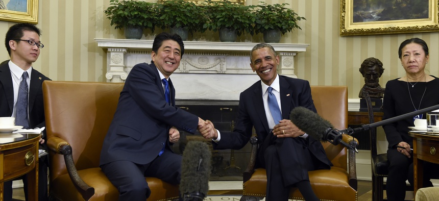 President Barack Obama shakes hands with Japanese Prime Minister Shinzo Abe during their meeting in the Oval Office of the White House in Washington, Tuesday, April 28, 2015.