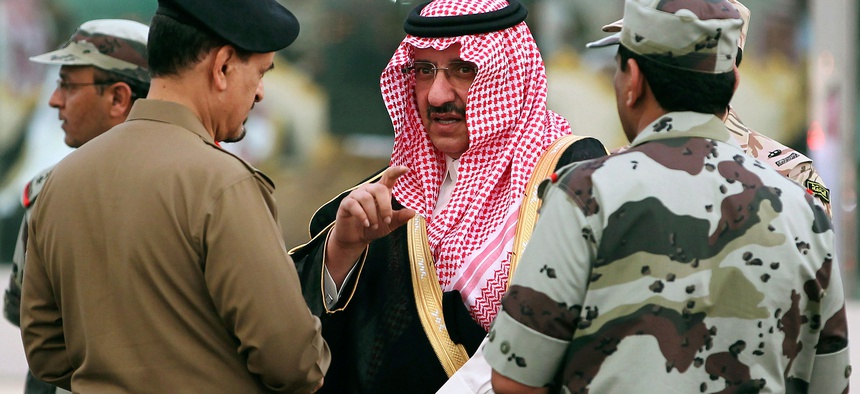 Prince Mohammed bin Nayef bin Abdul Aziz, Saudi Deputy Interior Minister at the time, speaks with Saudi officials while he attends a martial parade of Saudi armed forces outside Mecca in October 2012.