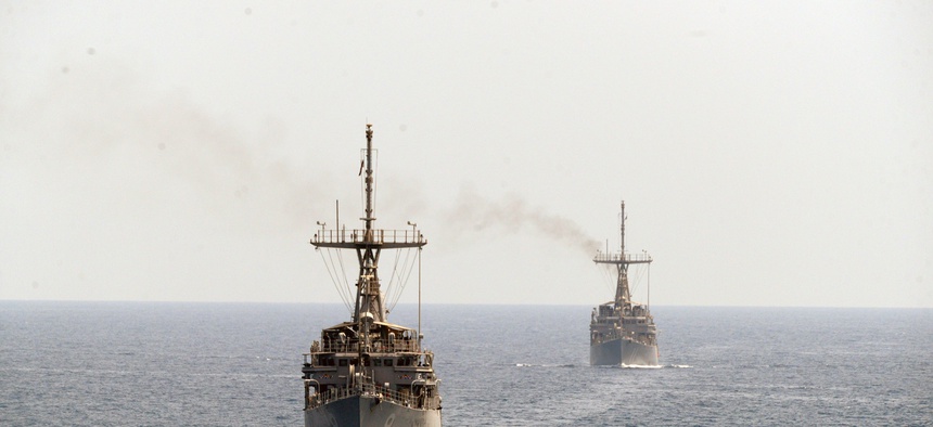 The mine countermeasure ships USS Scout (MCM 8), left, and USS Gladiator (MCM 11), transit the Strait of Hormuz.