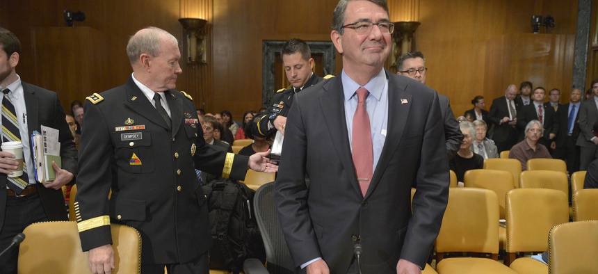 Secretary of Defense Ash Carter glances around the room as he and Chairman of the Joint Chiefs of Staff Army Gen. Martin Dempsey prepare to testify before the Senate Appropriations Committee's defense subcommittee, in Washington, D.C., May 6, 2015.