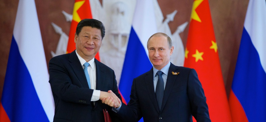 Russian President Vladimir Putin, right, and Chinese President Xi Jinping shake hands at the signing ceremony in the Kremlin in Moscow, Friday, May 8, 2015.