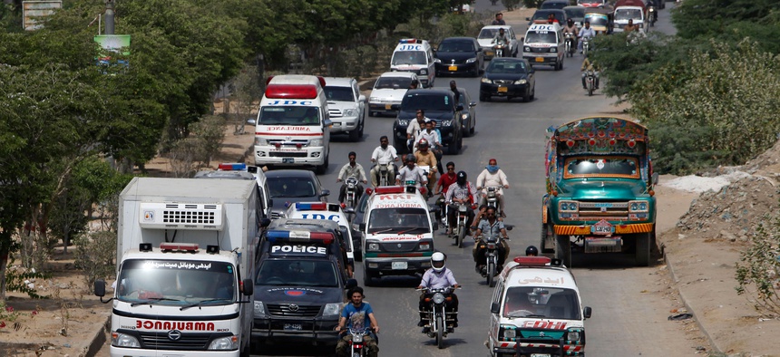 Ambulances take bodies of attack victims to a hospital for autopsies in Karachi, Pakistan, Wednesday, May 13, 2015