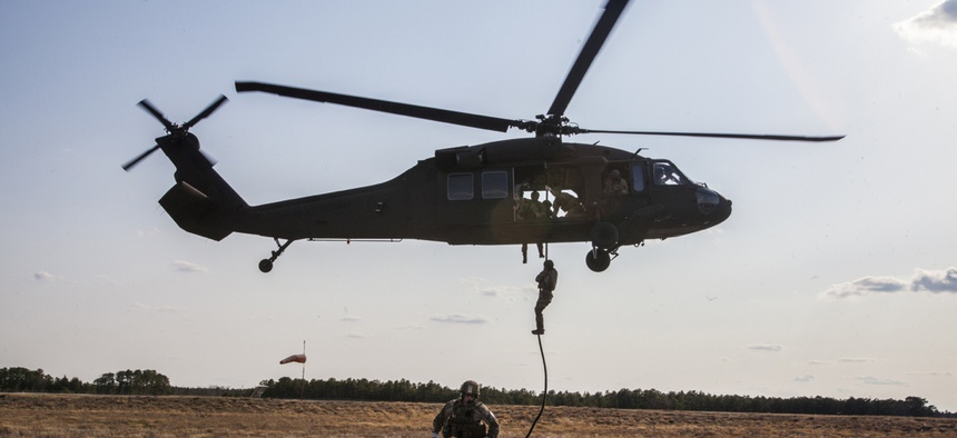 Special operations airmen repel from an Army National Guard Blackhawk helicopter while training in New Jersey.