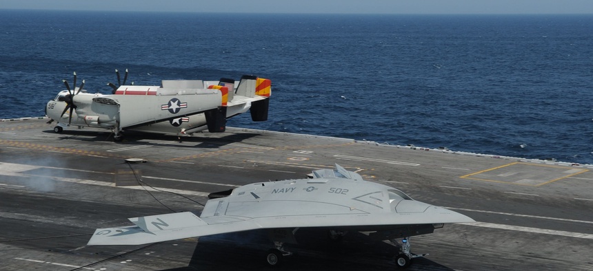 An U.S. Navy X-47B Unmanned Combat Air System demonstrator aircraft makes an arrested landing on the flight deck of the aircraft carrier USS George H.W. Bush (CVN 77) July 10, 2013.