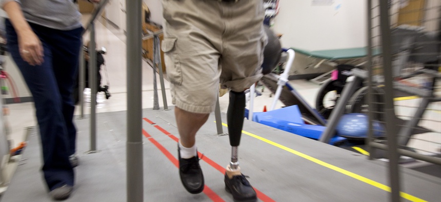 A Vietnam War veteran tries out a new prosthetic leg at the Walter Reed Army Medical Center.