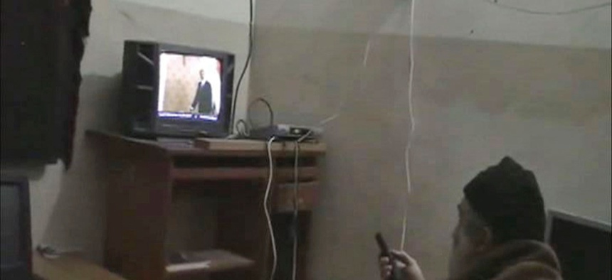 This undated image from video seized from the walled compound of al-Qaida leader Osama bin Laden in Abbottabad, Pakistan and released by the U.S. Department of Defense shows a man identified by the U.S. government as Osama Bin Laden in front of a TV.