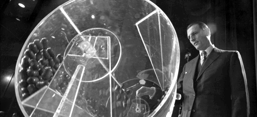 Draft Director Curtis W. Tarr is shown spinning a plexiglass drum at the beginning of the fourth annual Selective Service lottery in Washington in this Feb. 2, 1972 file photo.