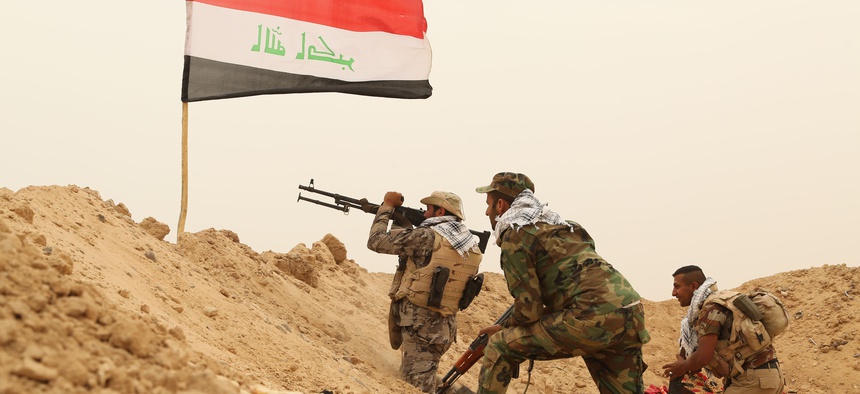 Fighters from the Badr Brigades Shiite militia clash with Islamic State militant group at the front line, on the outskirts of Fallujah, Anbar province, Iraq, Monday, June 1, 2015.