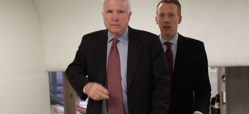 Sen. John McCain, R-Ariz., and a staff member walk on Capitol Hill in Washington, Wednesday, Feb. 25, 2015.