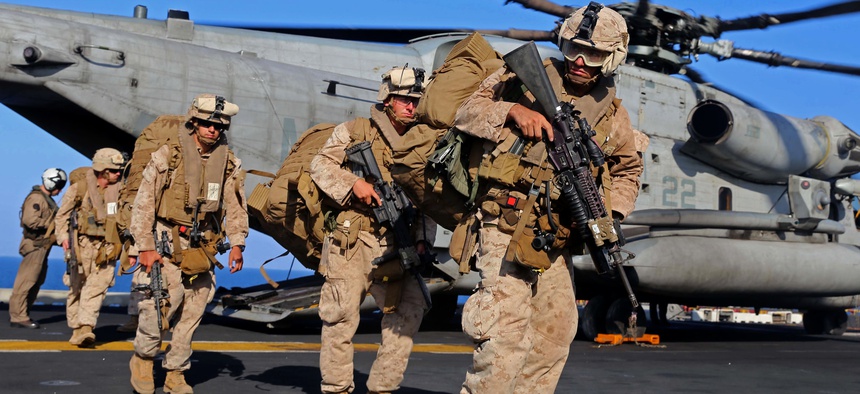Marines with the 11th Marine Expeditionary Unit (MEU), off-load from a CH-53E Super Stallion on Dec. 12, 2014.