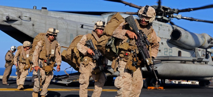Marines with the 11th Marine Expeditionary Unit (MEU), off-load from a CH-53E Super Stallion on Dec. 12, 2014.