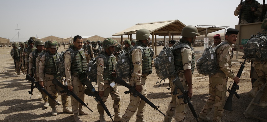 Soldiers from the 76th Iraqi Army Brigade prepare to load a truck with their new M16A2 rifles and military equipment at the Taji Military Complex, Iraq, May 24, 2015.