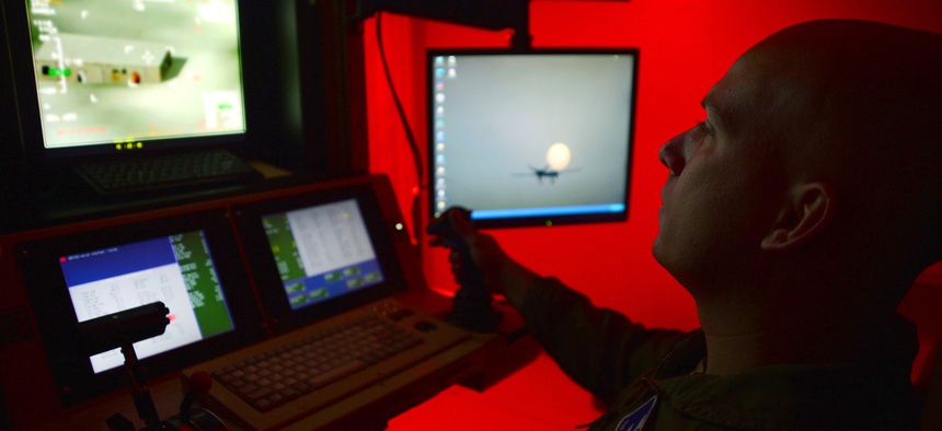 Tech. Sgt. Jason, 91st Attack Squadron sensor operator, flies a simulated training mission on an MQ-9 Reaper at Creech Air Force Base, Nev., May 8, 2014.