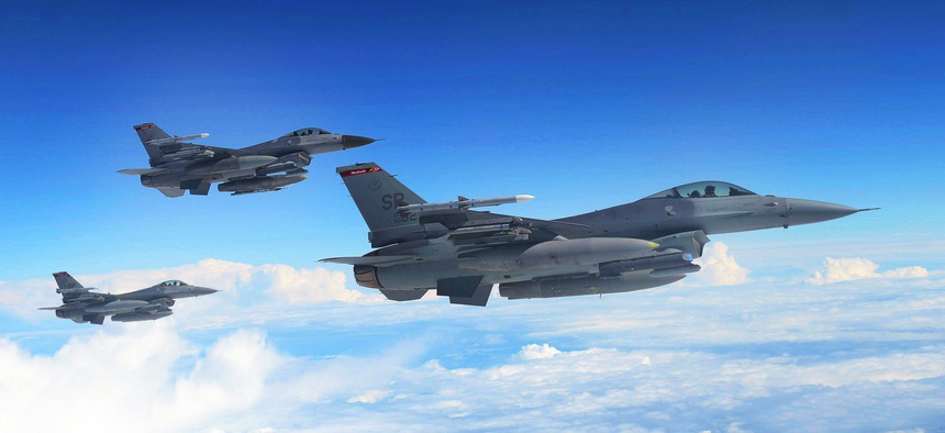 U.S. Air Force F-16 Fighting Falcons await refueling from a KC-135 Stratotanker assigned to the 351st Expeditionary Air Refueling Squadron-Poland June 13, 2014.