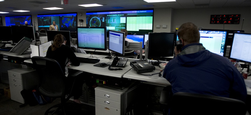 Specialists work at the National Cybersecurity and Communications Integration Center (NCCIC) in Arlington, Va., Tuesday, Sept. 9, 2014.