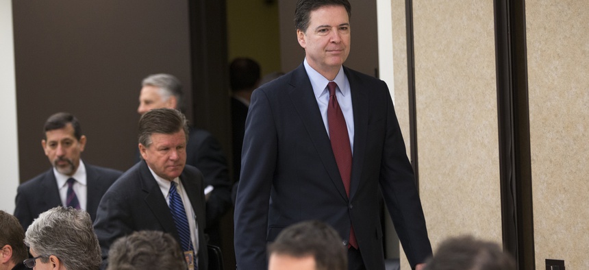 FBI director James Comey arrives for a news conference at FBI headquarters in Washington, Wednesday, March 25, 2015.