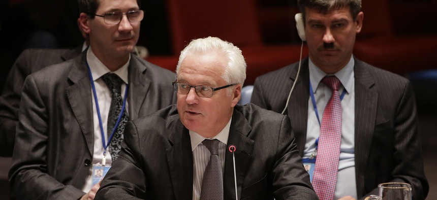 Russian permanent resident to the United Nations, Vitaly Churkin, center, speaks to the U.N. Security Council, Friday, Sept. 19, 2014.