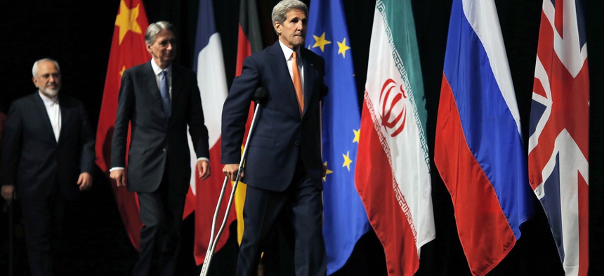 U.S. Secretary of State John Kerry, centre British Foreign Secretary Philip Hammond, centre and Iranian Foreign Minister Mohammad Javad Zarif arrive for a group picture at the Vienna International Center in Vienna, Austria, Tuesday, July 14, 2015.