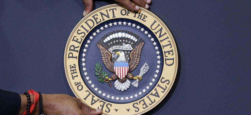 The presidential seal is placed on the podium ahead of President Barack Obama's visit to Lackawanna College Friday, Aug. 23, 2013, in Scranton, Pa.