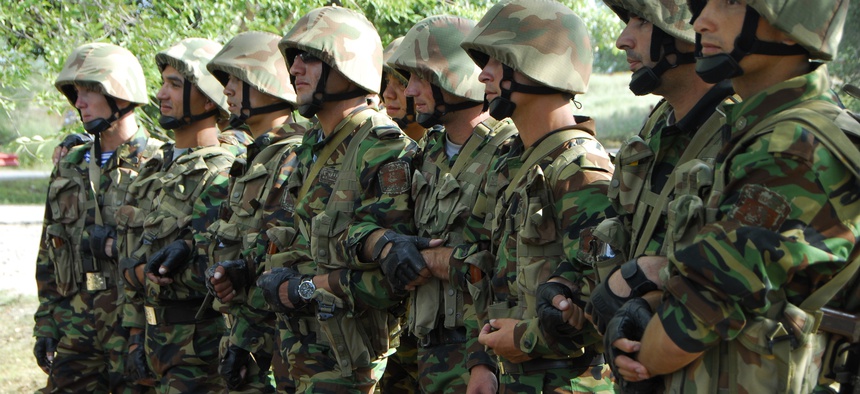 Tajikistani soldiers form a human barricade while conducting riot control operations during Steppe Eagle 2013 at the Iliskiy Training Center in the Almaty region of Kazakhstan, Aug. 13, 2013.
