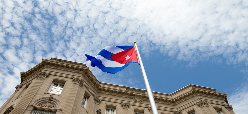 The Cuban flag is raised over their new embassy in Washington, Monday, July 20, 2015.