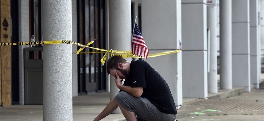 Ryan Scafe prays in front of the Armed Forces Career Center Monday, July 20, 2015, in Chattanooga, Tenn.