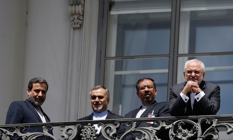 Iranian Foreign Minister Mohammad Javad Zarif reacts as he stands on a balcony with other members of his delegation outside of the current round of Iran nuclear talks, being held in Vienna, Austria July 10, 2015. Iranian Foreign Minister Mohammad Javad Zarif reacts as he stands on a balcony with other members of his delegation outside of the current round of Iran nuclear talks, being held in Vienna, Austria July 10, 2015.