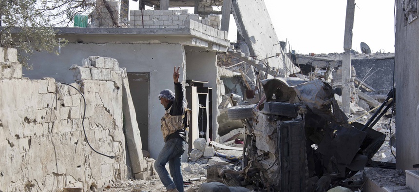 In this Nov. 19, 2014, file photo, a Free Syrian Army fighter from Shams al-Shamal heads to the front line in Kobani, Syria.