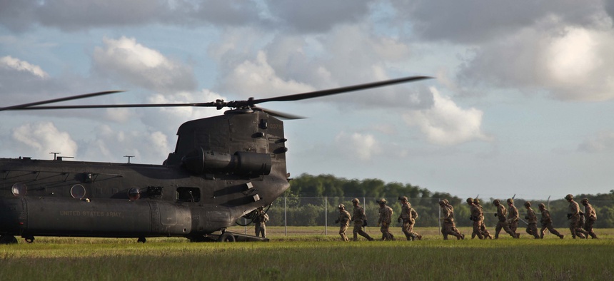 Army Rangers of 1st Battalion, 75th Ranger Regiment, prepare to enter an MH-47 helicopter to execute fast rope training at Hunter Army Airfield, Ga. June 2, 2014.