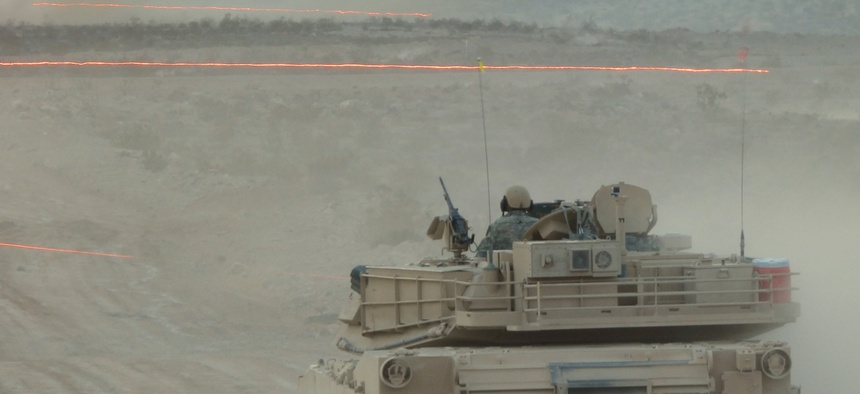 Tracer fire whizzes by an Army Abrams tank during a Joint Forcible Entry Exercise on Aug. 5.
