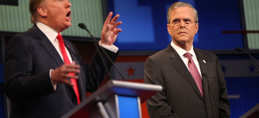 Republican presidential candidate Jeb Bush listens as Donald Trump speaks during the first Republican presidential debate at the Quicken Loans Arena Thursday, Aug. 6, 2015, in Cleveland.