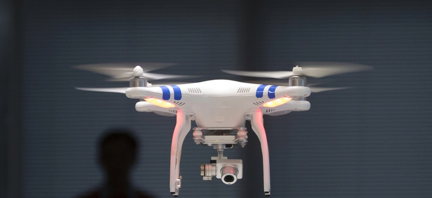 A staff member from DJI Technology Co. demonstrates remote flying with his Phantom 2 Vision+.