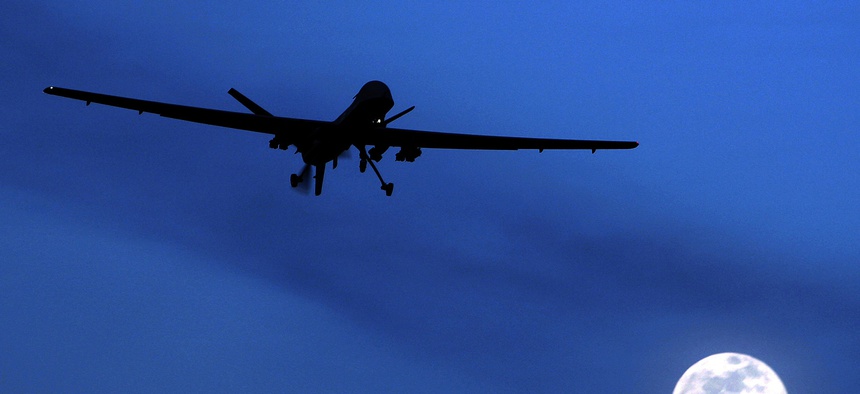 An unmanned U.S. Predator drone flies over Kandahar Air Field, southern Afghanistan, on a moon-lit night in 2010.