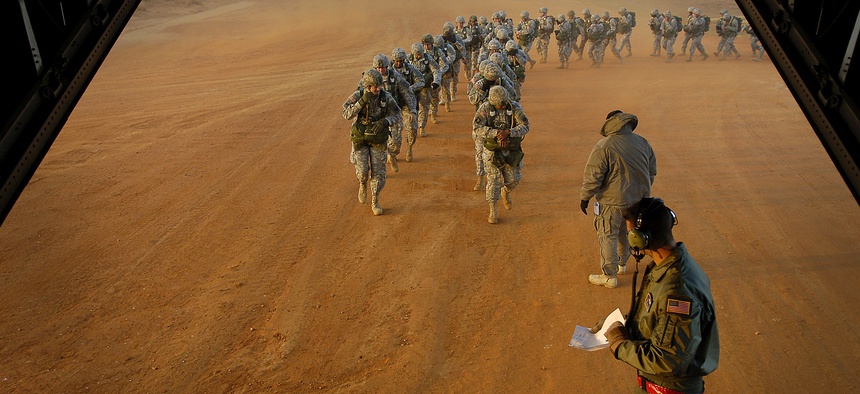 U.S. Army paratroopers prepare to board a C-130 Hercules during Operation Toy Drop, Ft. Bragg, N.C., December 8, 2007.