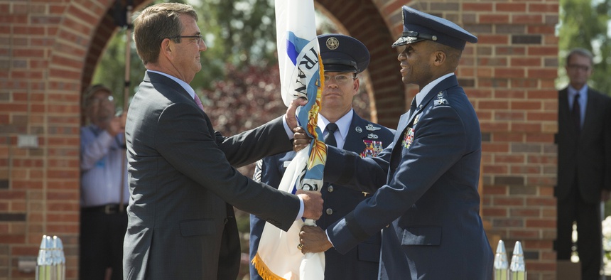 Defense Secretary Ash Carter hands the U.S. Transportation Command colors to new Commander Gen. Darren McDew, Aug. 26, 2015 at Scott Air Force Base, Ill.