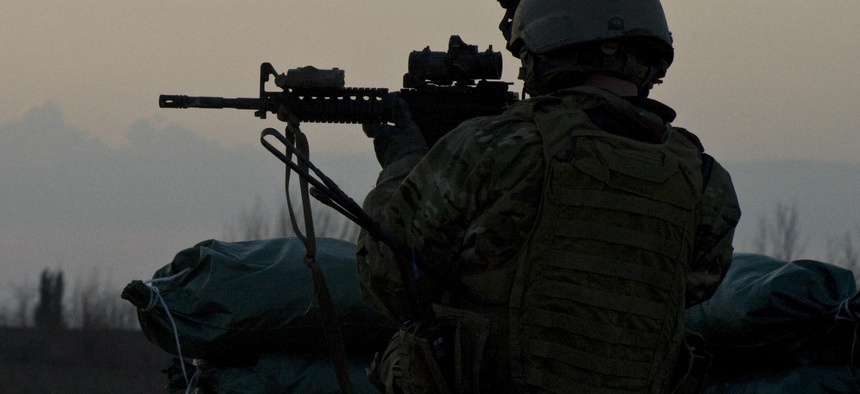 A U.S. Army military information support operations sergeant with Special Operations Task Force-South provides security overwatch in Kandahar province's Zharay District in Afghanistan in 2011.