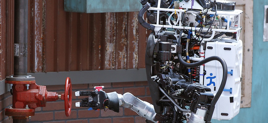 Robot Running Man from the Florida Institute for Human and Machine Cognition proceeds to turn a valve in the U.S. Defense Advanced Research Projects Agency Robotics Challenge in Pomona, Calif.