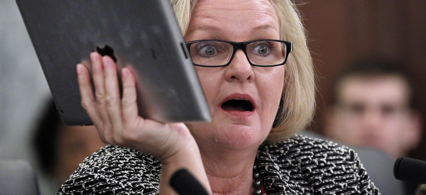 Sen. Claire McCaskill, D-Mo., holds up her Apple IPad during a hearing of the Subcommittee on Consumer Protection, Product Safety, and Insurance on cell phone privacy on Capitol Hill Thursday, May 19, 2011 in Washington.