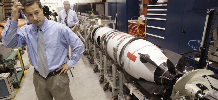 Christopher Del Mastro, head of anti submarine warfare mobil targets stands next to an unmanned underwater vehicle (UUV) in a lab at the Naval Undersea War Center in Middletown, RI., Tuesday, July 31, 2012.