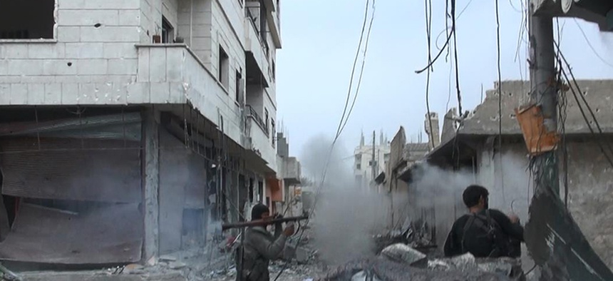 This undated file photo posted on Monday, Nov. 4, 2014 by the Raqqa Media Office of the Islamic State group, a militant extremist group, shows fighting in Kobani, Syria.