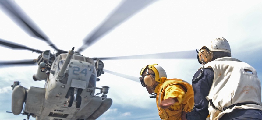 In the Pacific Ocean, a CH-53E Super Stallion lifts off the flight deck of the amphibious dock landing ship USS Ashland (LSD 48), Aug. 17, 2015.