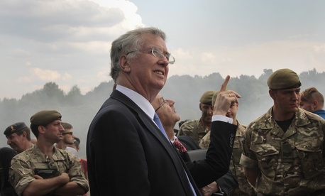 British Secretary of State for Defense, Michael Fallon, watches proceedings as British serviceman teach Ukrainian soldiers on the military base outside Zhitomir, Ukraine, Tuesday, Aug. 11, 2015. British Secretary of State for Defense, Michael Fallon, watches proceedings as British serviceman teach Ukrainian soldiers on the military base outside Zhitomir, Ukraine, Tuesday, Aug. 11, 2015.