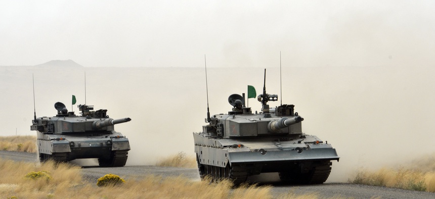 Japanese tankers from the 3rd Combat Team of the Japan Ground Self-Defense Force assault enemy positions during a live fire training exercise Sept. 22, 2012 at the Yakima Training Center.