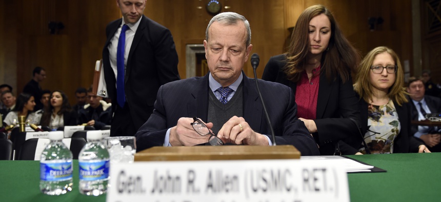 Special Presidential Envoy for the Global Coalition to Counter IS, retired Gen. John R. Allen prepares to testify on Capitol Hill, Feb. 25, 2015, before the Senate Foreign Relations Committee.