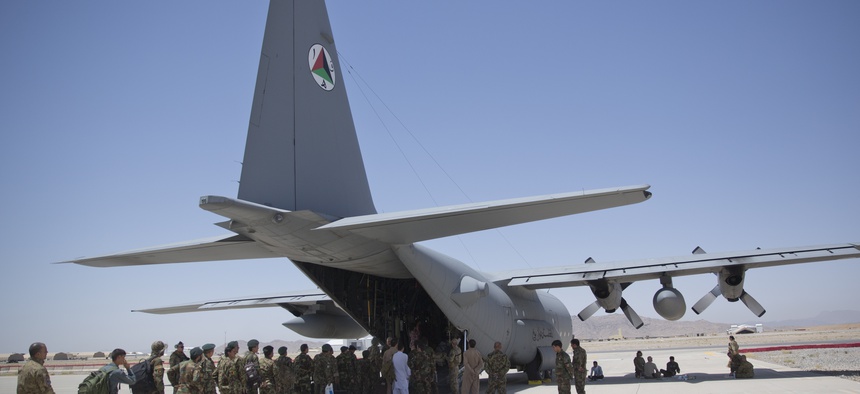 In this Tuesday, Aug. 18, 2015 photo, Afghan National Army soldiers line up to get into a C-130 Hercules, at Kandahar Air Base, in Kandahar, Afghanistan.