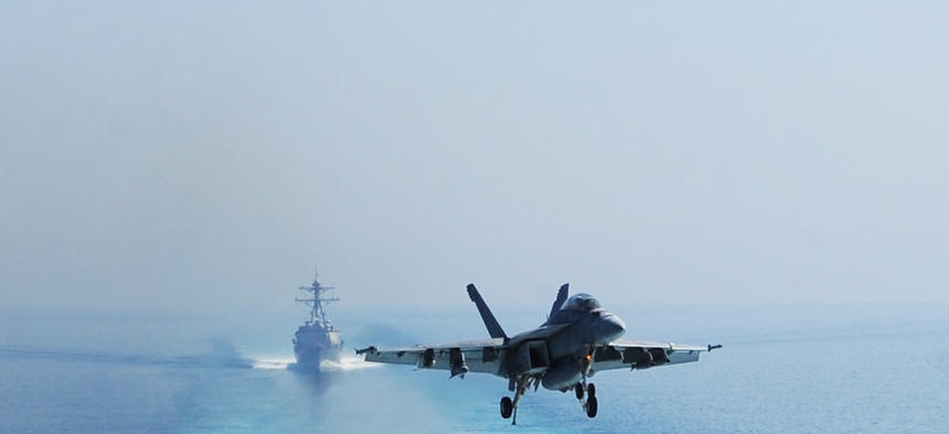 A U.S. Navy F/A-18F Super Hornet aircraft prepares to land on the flight deck of the aircraft carrier USS George H.W. Bush (CVN 77), not shown, in the Persian Gulf Oct. 3, 2014, in operations against the Islamic State in Iraq and Syria.