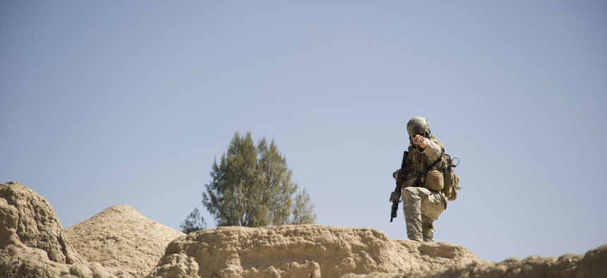 A U.S. Special Forces sergeant directs security positions during a patrol Feb. 20, 2011 in Panjwai District, Kandahar province, Afghanistan.