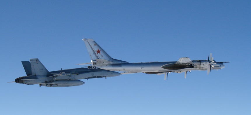 A CF-18 Hornet from 4 Wing Cold Lake flies next to a Russian Tu-95 Bear bomber on September 5.