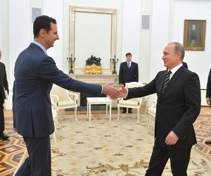n this photo taken on Tuesday, Oct. 20, 2015, Russian President Vladimir Putin, right, shakes hand with Syrian President Bashar Assad in the Kremlin in Moscow, Russia.